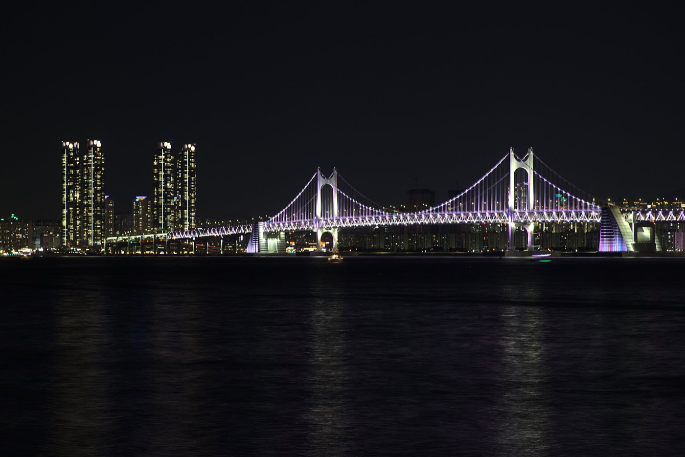 The Gwangan Bridge lit at night, seen across the water from Marine City, Busan