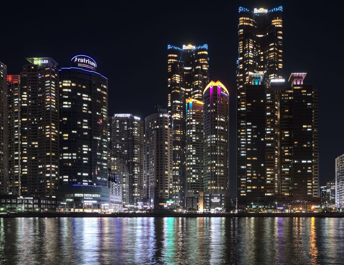 The Marine City towers of Haeundae lit at night across the water